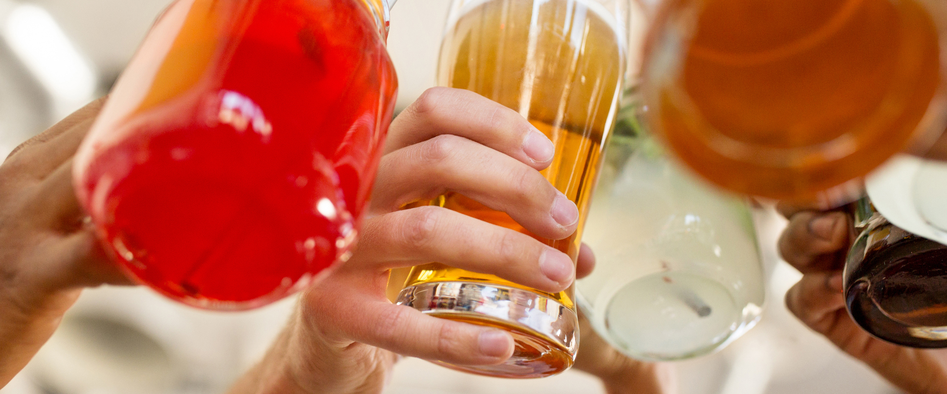 leisure, food and people concept - group of happy international friends clinking glasses at bar or restaurant